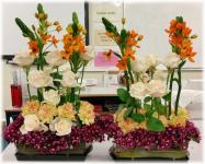 Carnation, Roses (Vendela Cream).  Ornit db (Orange Fire). The base was Sweet William on floral foam bricks, the outside of the bricks wrapped with Phormium leaves.