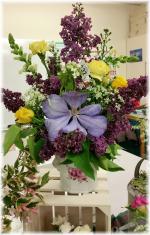 Using vintage style containers, bottles, jars & jugs.  Some arrangements used Chicken wire to hold the arrangements, others were held in place by volume of flowers and plant material.