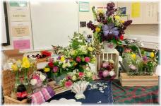 Using vintage style containers, bottles, jars & jugs. Some arrangements used Chicken wire to hold the arrangements, others were held in place by volume of flowers and plant material.