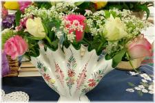 Vintage style containers, bottles, jars & jugs.  Some arrangements used Chicken wire to hold the arrangements, others were held in place by volume of flowers and plant material.