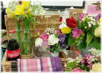 Using vintage style containers, bottles, jars & jugs. Some arrangements used Chicken wire to hold the arrangements, others were held in place by volume of flowers and plant material.