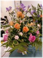 End of Colonial Williamsberg Era 1781. ~~ Flowers: Roses, Freesia, Spray Carnation. ~~ Container: Metal Urn. Pineapple & other fruit would have been added.  Style: Open_Haphazard