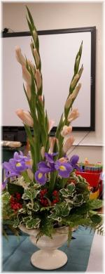 Flowers: Peach Gladiolus, Iris. ~~~ Container: Ceramic Pedestal Vase. ~~~ Style: Slender more elegant designs
