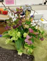 Flowers used - Daffodil, Hyacinth & Hellebores (Christmas Roses - from her garden).  The container is formed using old records moulded into shape.